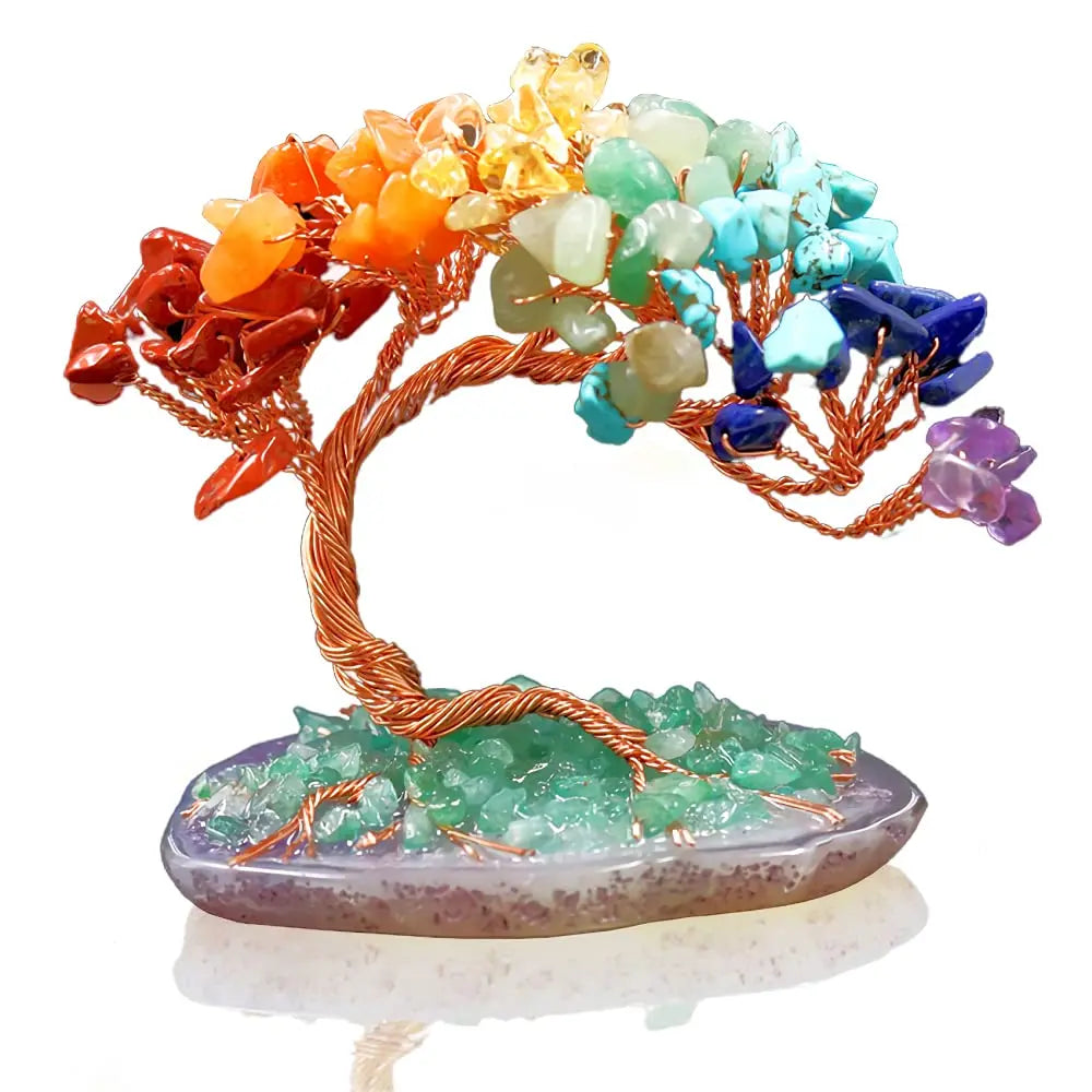 Crystal bonsai tree with colorful stones on a white background