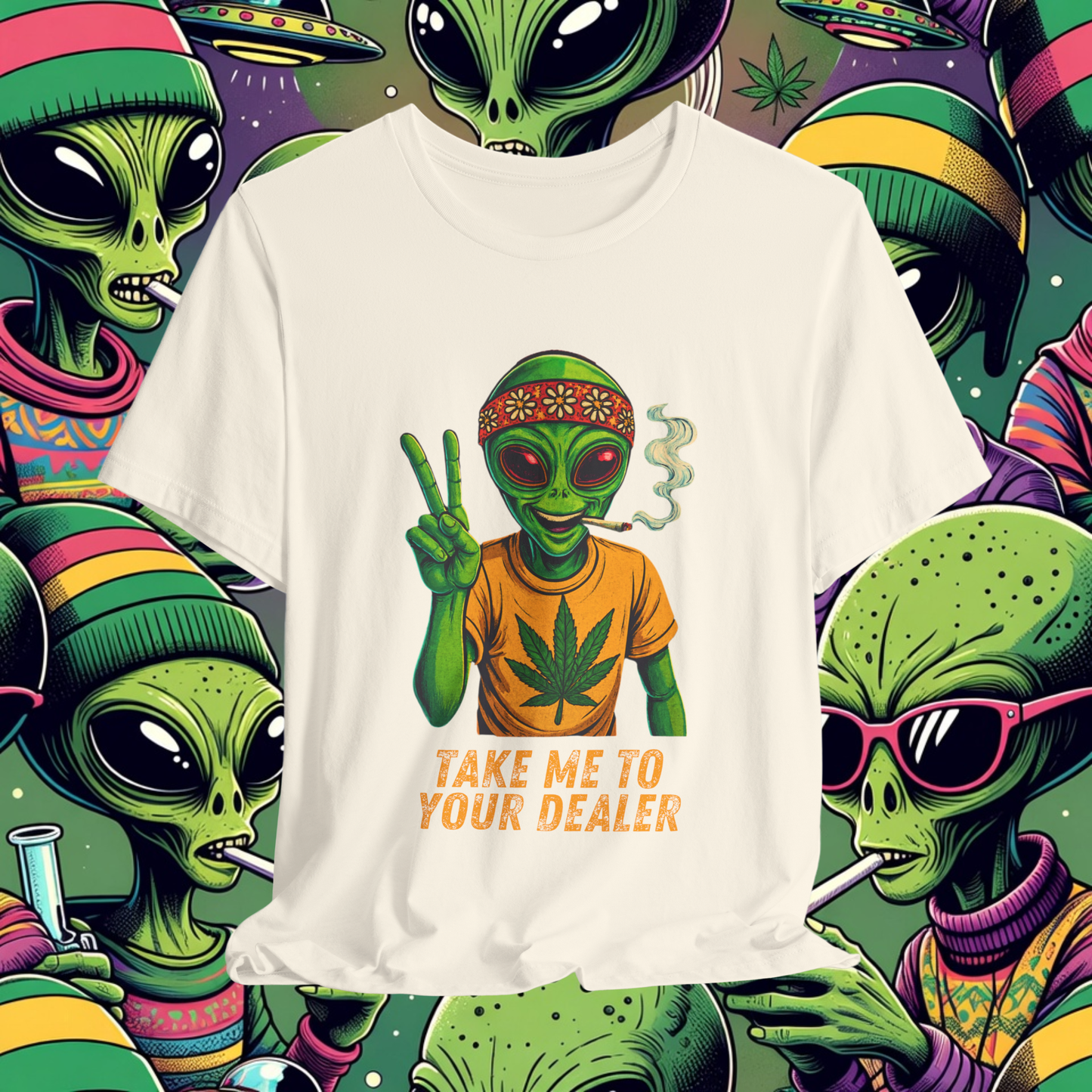 White t-shirt with alien graphic and text 'Take me to your dealer' on a colorful alien pattern background.